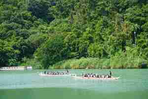 Dragon boat teams paddled through the scenic waters surrounded by verdant hillsides. (Photo by Chinese Language Center)(Open new window/jpg file)Image