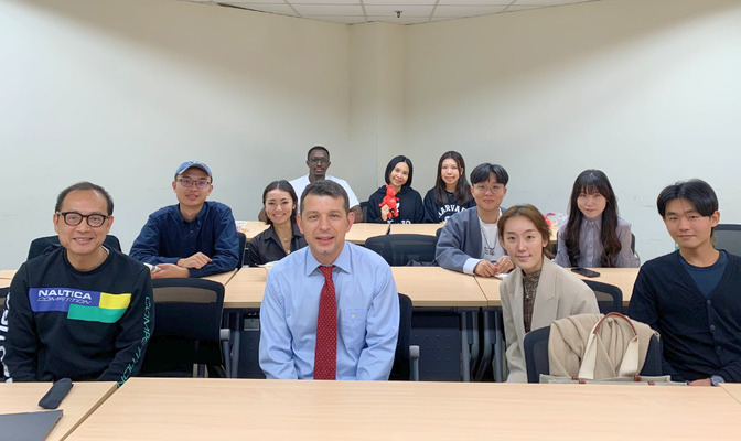 A group photo of Professor Andriy Bodnaruk with the attending faculty and students. (Photo by IMES)