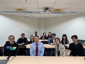 A group photo of Professor Andriy Bodnaruk with the attending faculty and students. (Photo by IMES)(Open new window/jpg file)Image