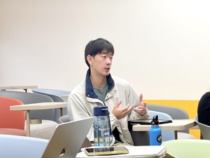 An IMICS student asks questions for the speaker.  (Photo by College of Communication)(Open new window/jpg file)Image