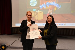 Professor Siaw-Fong Chung (right), EMI Resource Center Director, presents a certificate of appreciation to Dr. Krisztina Domjan (left), Professorial Lecturer, Office of Global and Immersive Studies Faculty, The American University, and points out the pun in the title of the talk. (Photo by EMI Resource Center)(Open new window/jpg file)Image