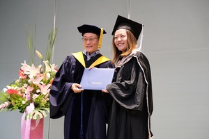 Grace awarding Diploma from Professor Edward Chow, PhD, Former President of NCCU. (Photo by College of Commerce)